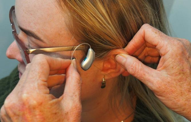 A woman being fited with a hearing aid