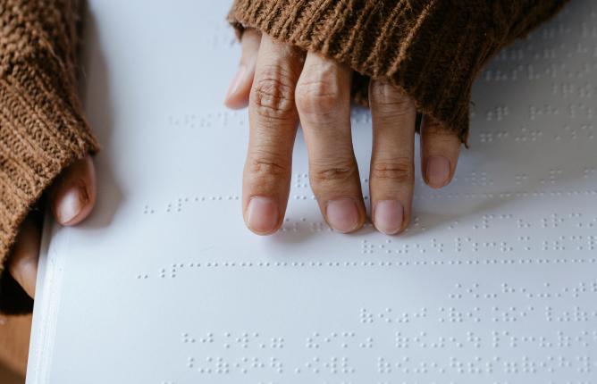 Hands reading Braille