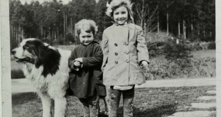 Archival photo of two children and a big fluffy dog