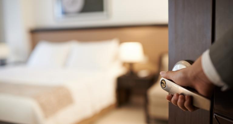 Hand opening door of nice hotel room