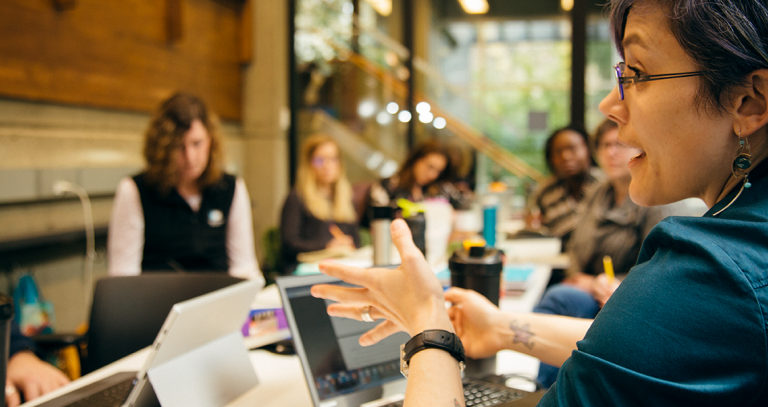 Group with laptops conversing