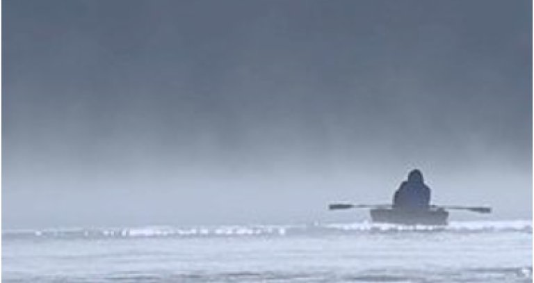 film cover shows a single person in a kayak in icy waters, facing away from camera. Everything is in greyscale.