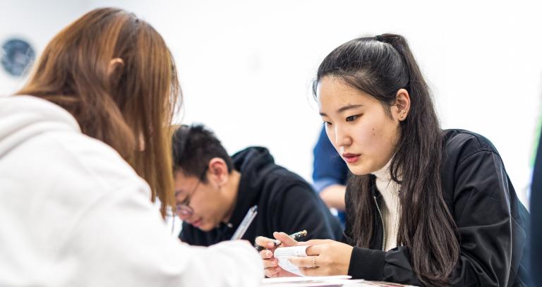 Three students studying in class