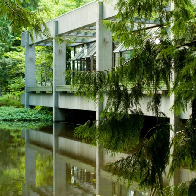 A deck on the lower level of the library extends out over the pond